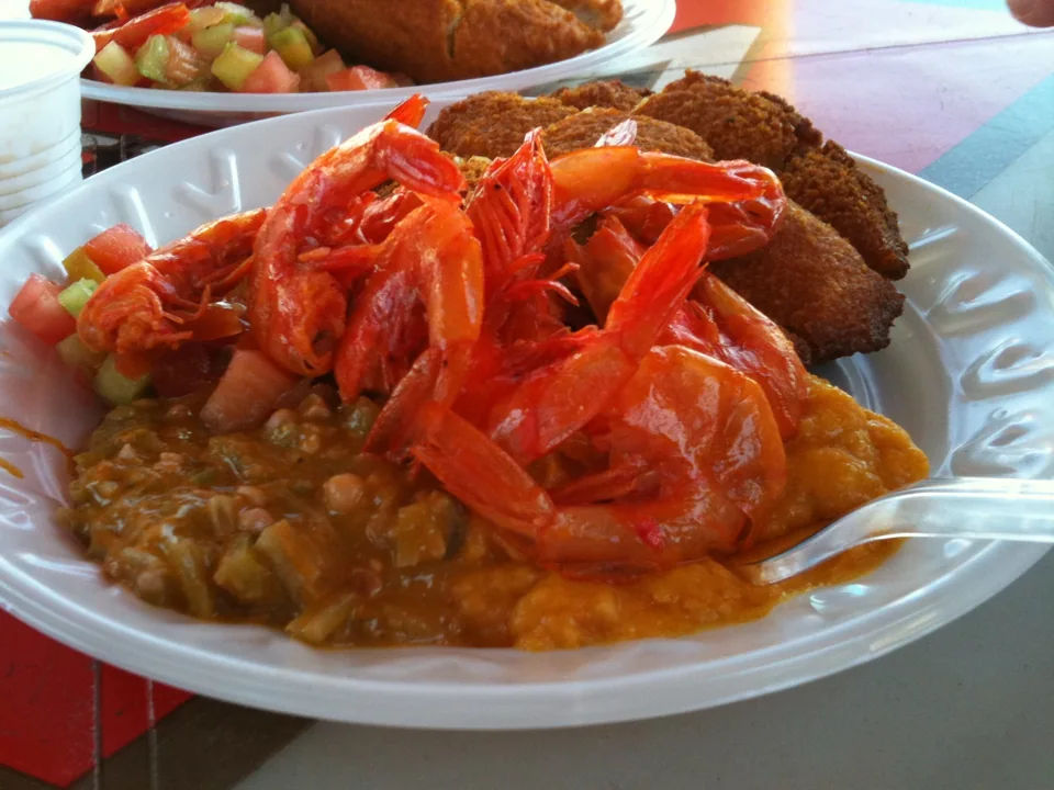 Acarajé split open with vatapá, shrimp and tomato vinaigrette