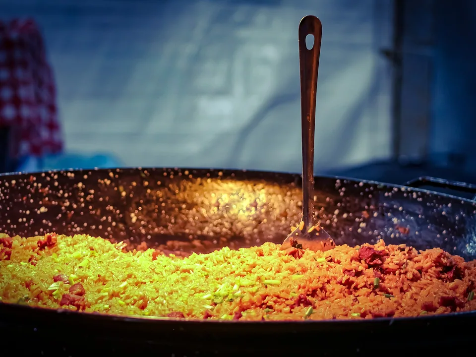 Arroz carreteiro with fluffy rice, dried beef, bacon, sausage and parsley