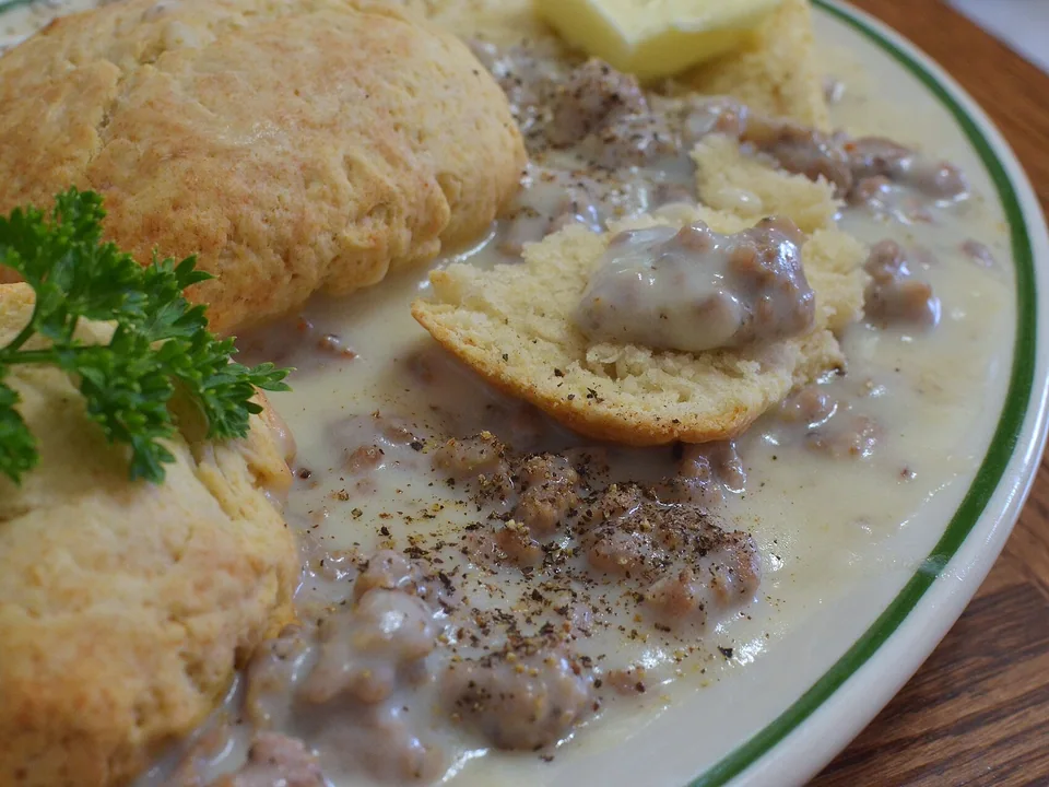 Flaky buttermilk biscuits covered in creamy sausage gravy