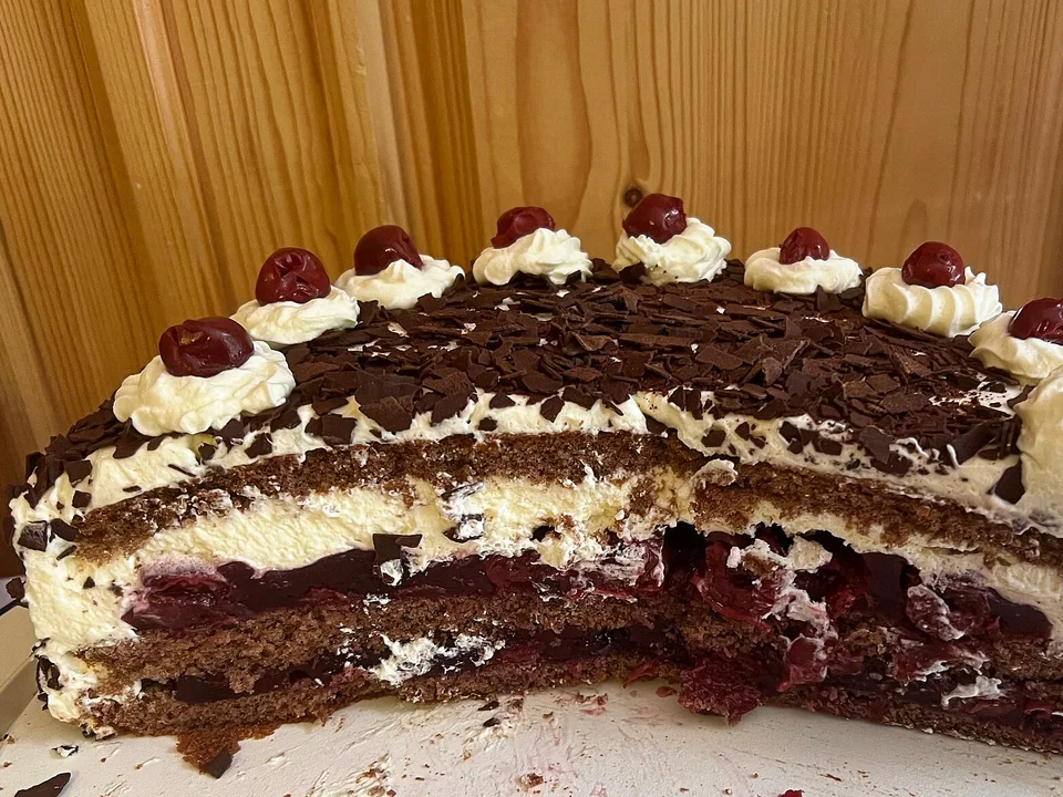 Traditional Black Forest cake with cream, cherries and dark chocolate curls
