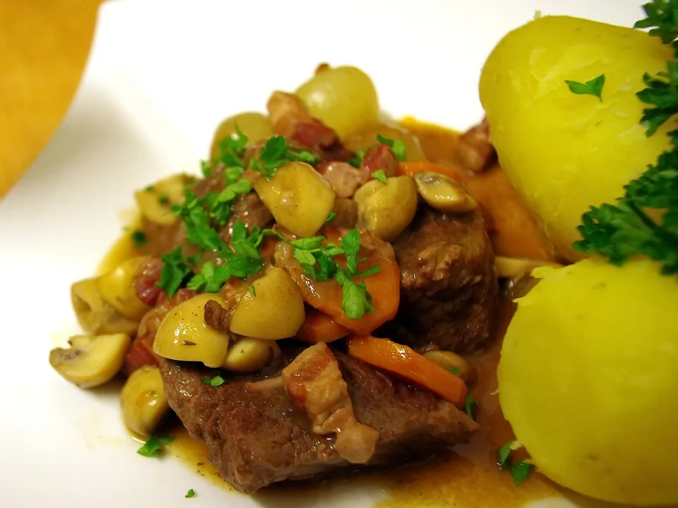 Red-wine braised beef with carrots, mushrooms, pearl onions, boiled potatoes and parsley