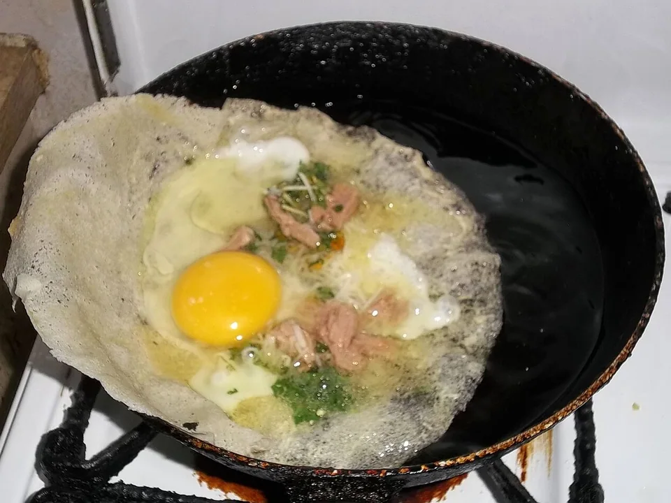 Golden Tunisian brik pastry folded around tuna, parsley, capers and egg, served with lemon