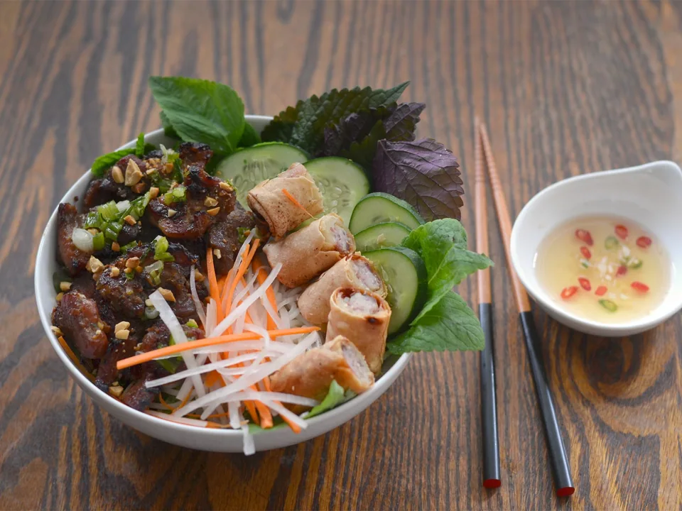 Grilled pork and rice vermicelli with lettuce, cucumber, pickles and crushed peanuts