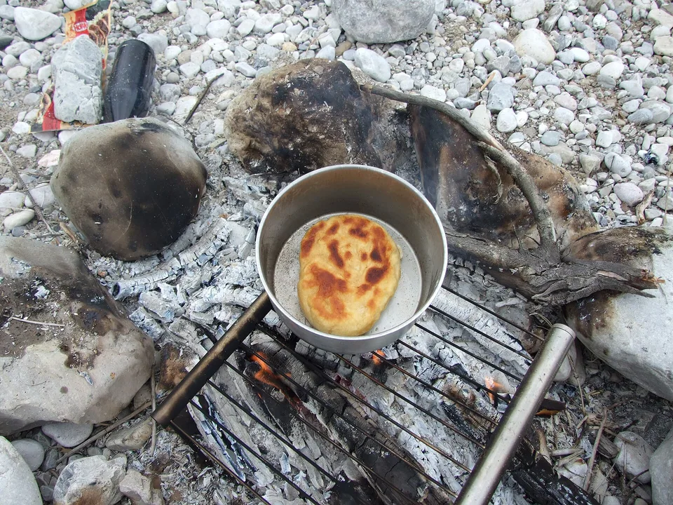 Rustic golden campfire bannock rounds made in a cast-iron skillet
