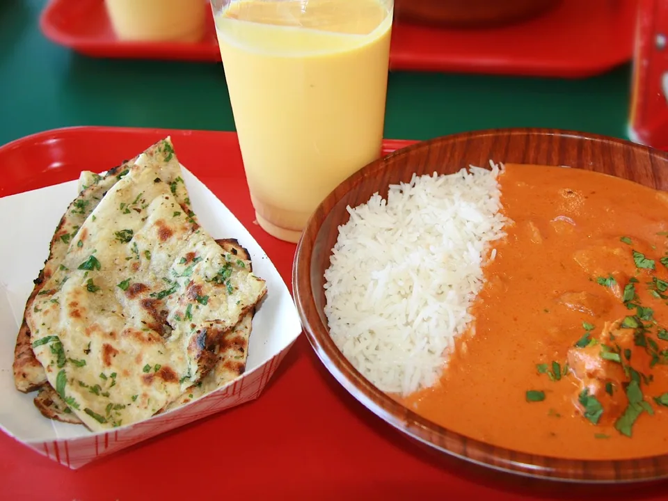 Charred chicken tikka in smooth orange masala sauce