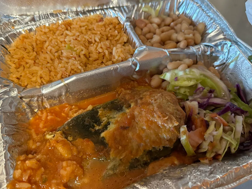 Golden cheese-filled chile relleno over red tomato salsa
