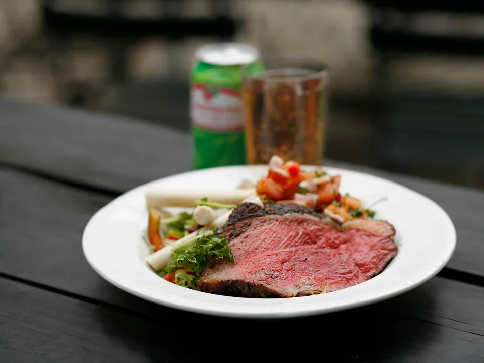 Sliced picanha with browned fat cap, egg farofa, tomato relish and rice