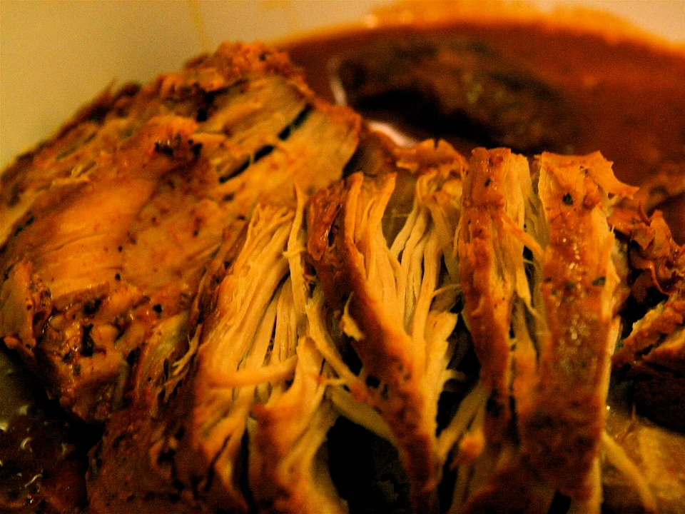 Cochinita pibil shredded in banana leaf with pink pickled onions