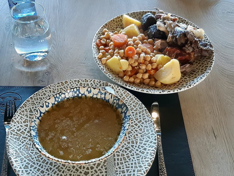 Madrid cocido served in separate courses with broth, chickpeas, vegetables and mixed meats
