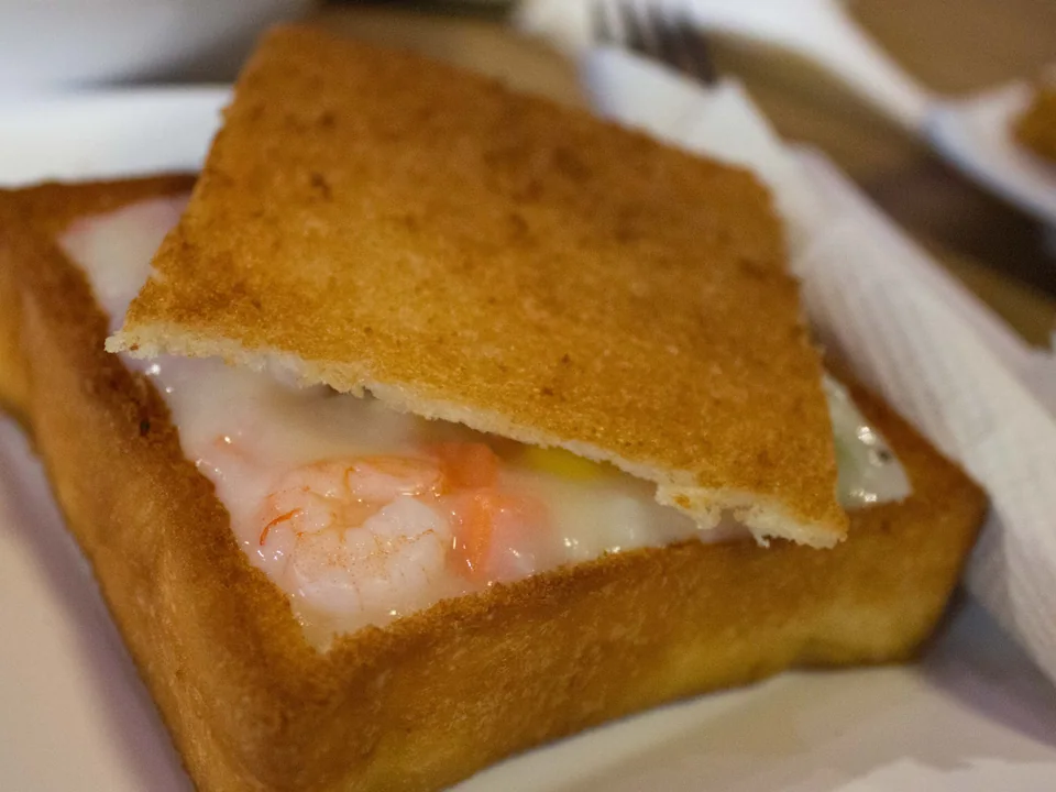 Tainan coffin bread with a crisp toast lid opened over creamy chicken-and-vegetable filling