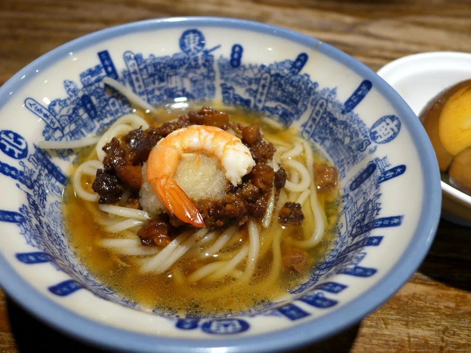 Small bowl of Tainan danzai noodles with pork sauce, bean sprouts, one shrimp, garlic, and cilantro