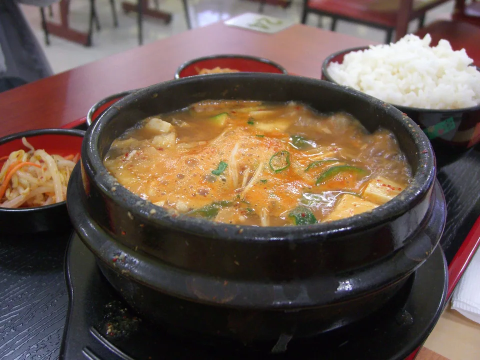 Rustic doenjang stew with tofu, zucchini, potato, and mushrooms