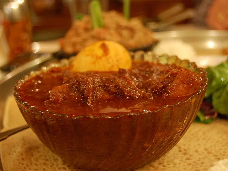 Ethiopian doro wat chicken stew with hard-cooked eggs in berbere sauce served with injera