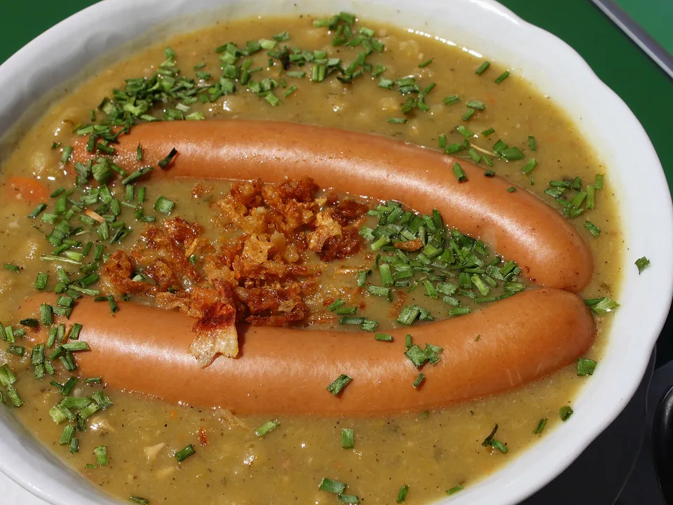 Thick German split-pea soup with smoked sausage, potato and parsley