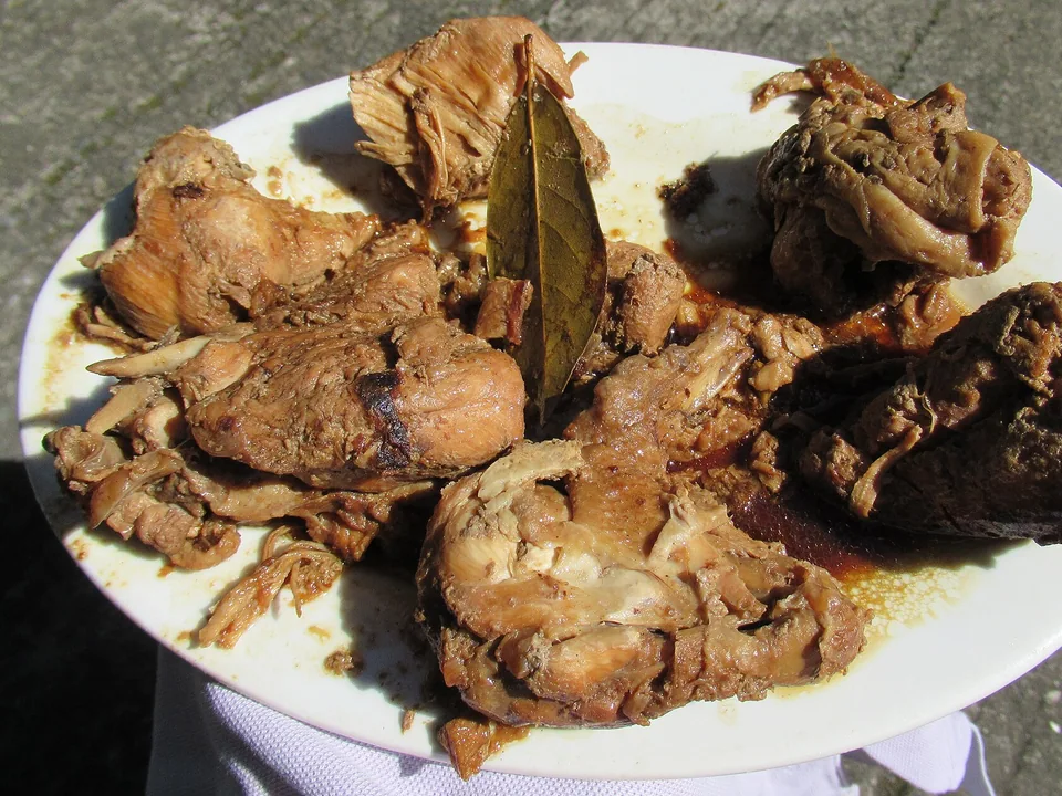 Filipino chicken adobo with peppercorns and bay leaves served over rice