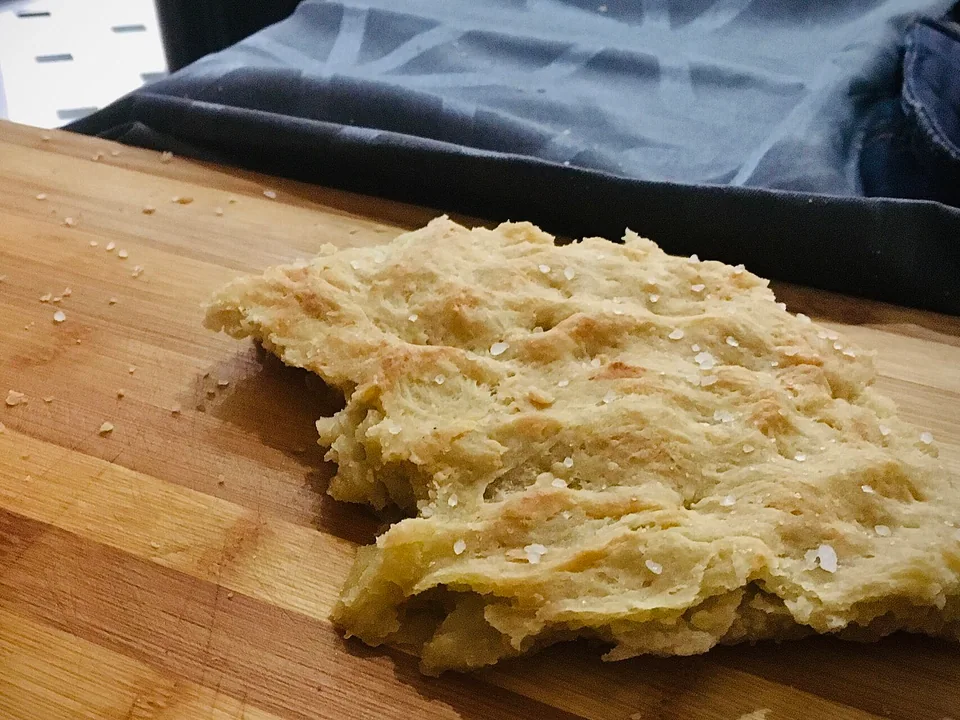 Golden focaccia Genovese with deep dimples and olive-oil sheen