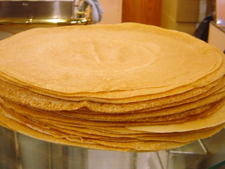 A stack of thin plain golden French crêpes