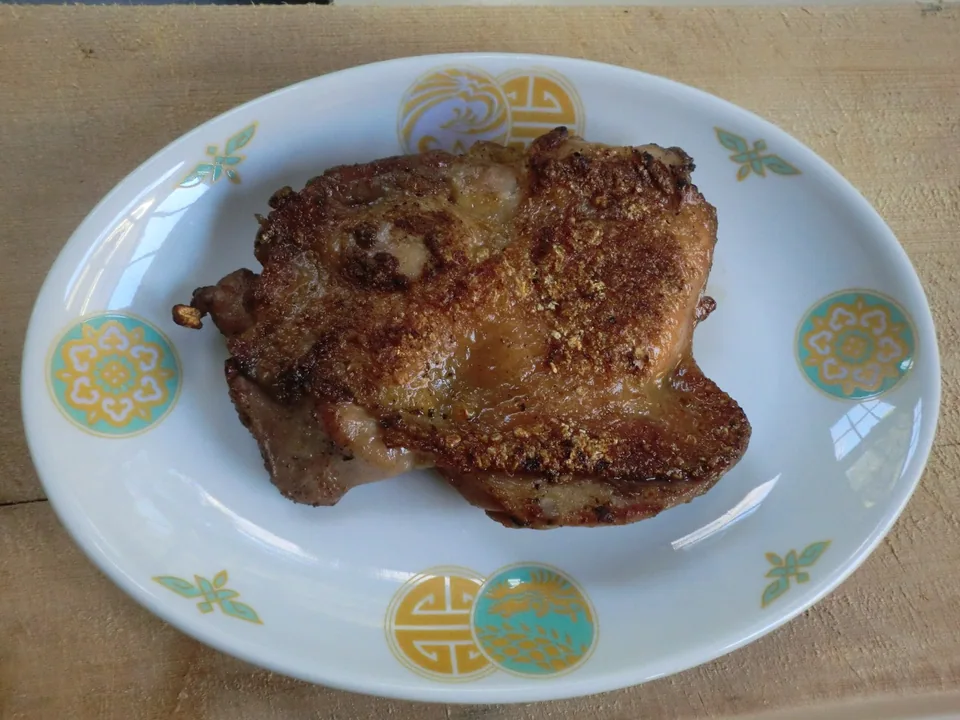 Thai Gai Yang grilled chicken leg with crisp browned skin and juicy fully cooked meat
