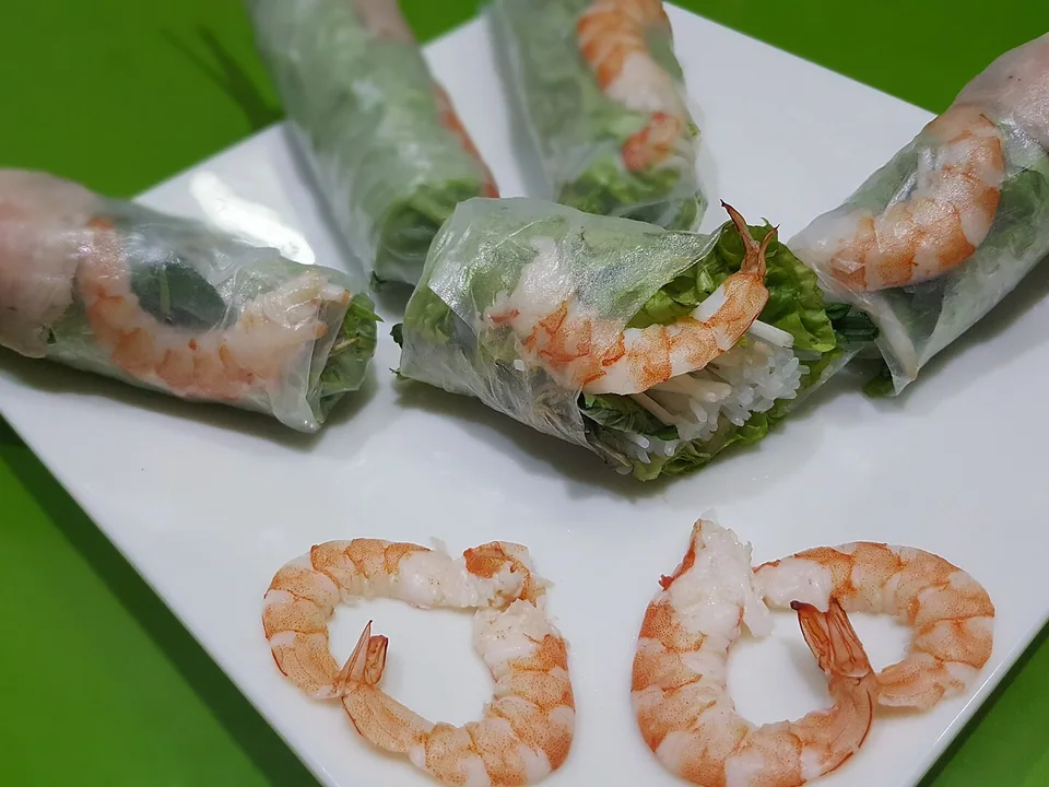 Translucent fresh shrimp and pork rice-paper rolls with herbs and peanut dipping sauce