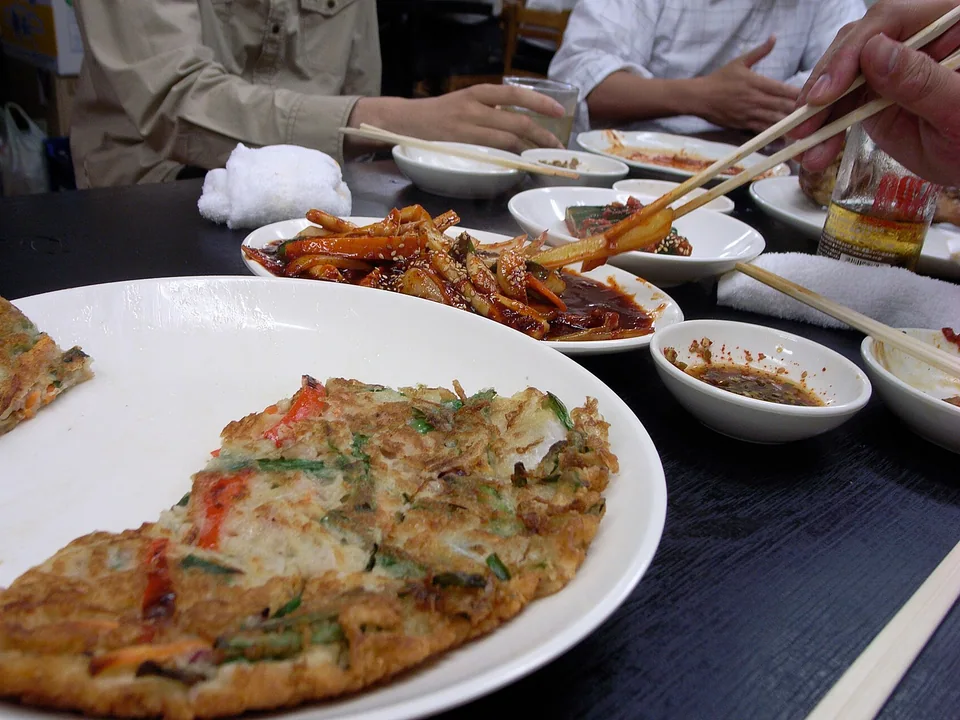 Crisp Korean scallion pancake with visible shrimp, squid, and mussels