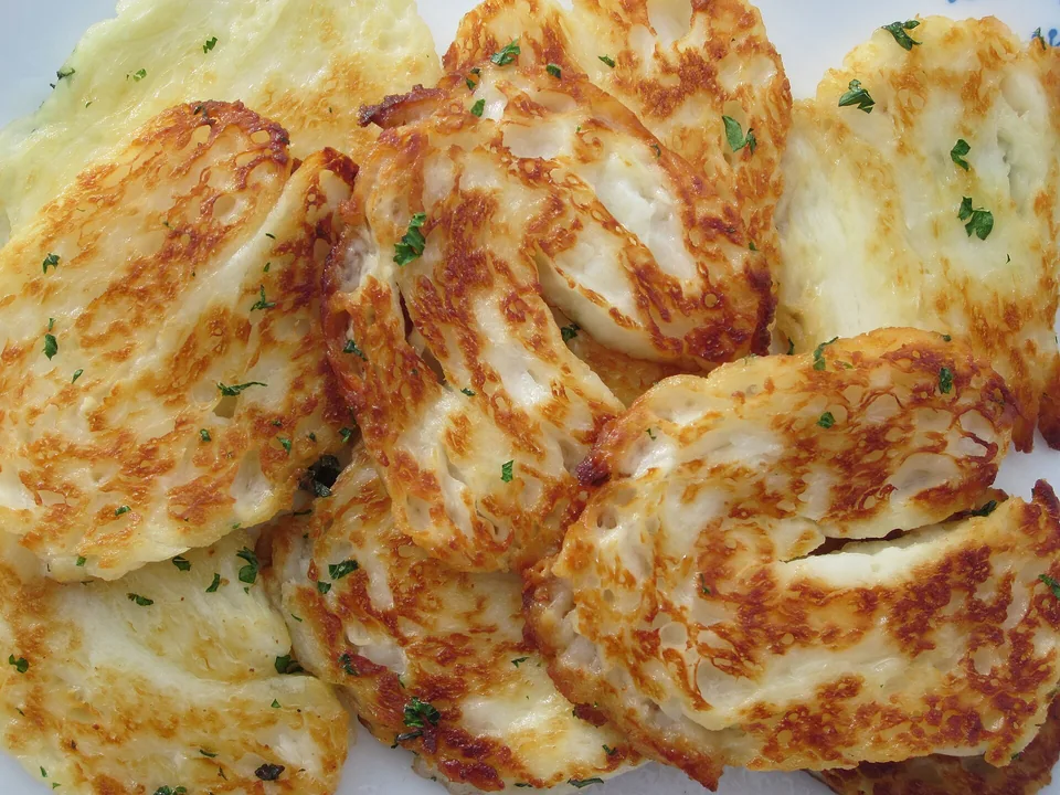 Golden pan-fried halloumi saganaki with lemon wedges and oregano