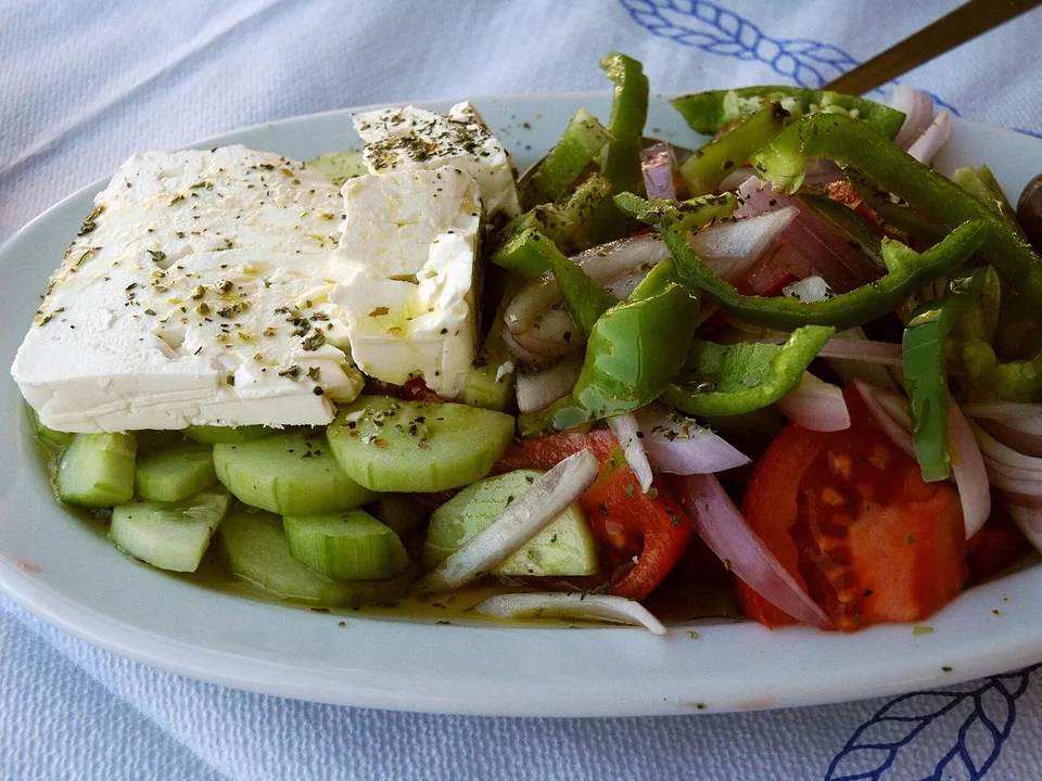 Greek horiatiki village salad with feta slab, tomato, cucumber and olives