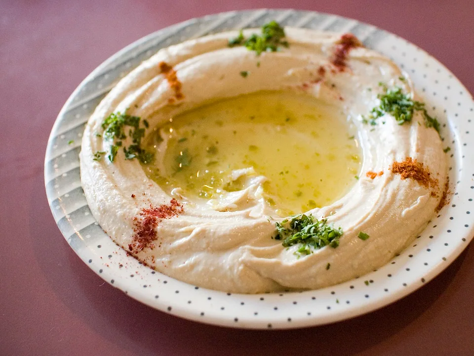 Smooth hummus topped with olive oil, sumac and chopped parsley