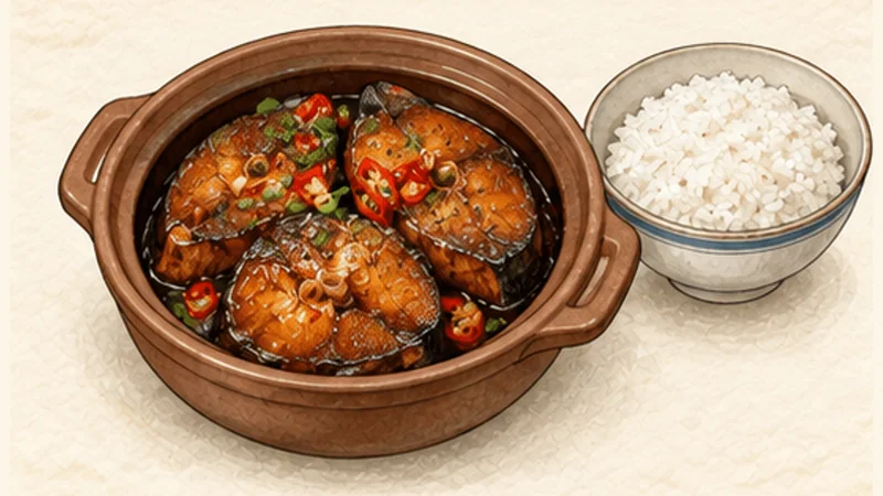 Cá kho tộ — caramel-braised fish, step 7: Finish with scallions.
