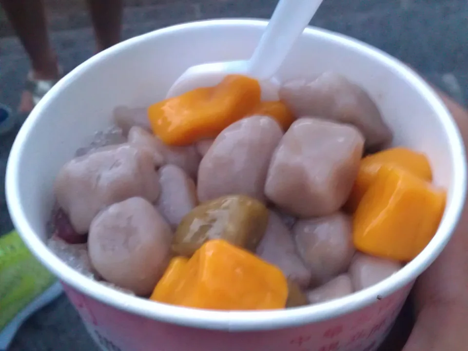Grey-purple taro balls and golden sweet potato balls in ginger brown-sugar syrup