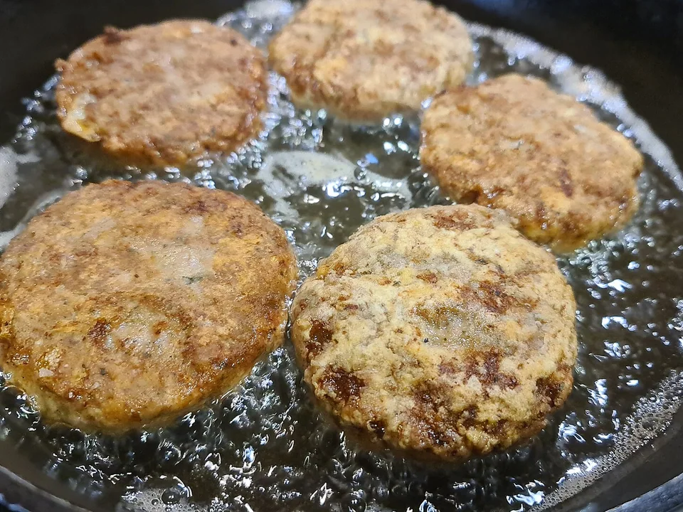 Deep-golden Greek keftedes meatballs with mint and parsley
