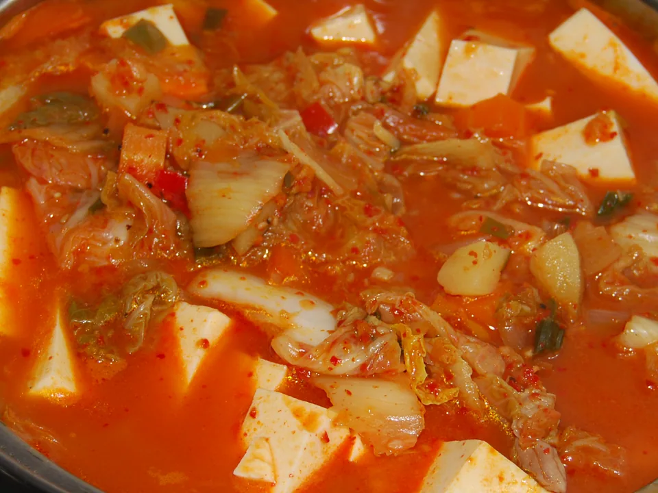 Red pork kimchi stew with tofu and softened napa cabbage