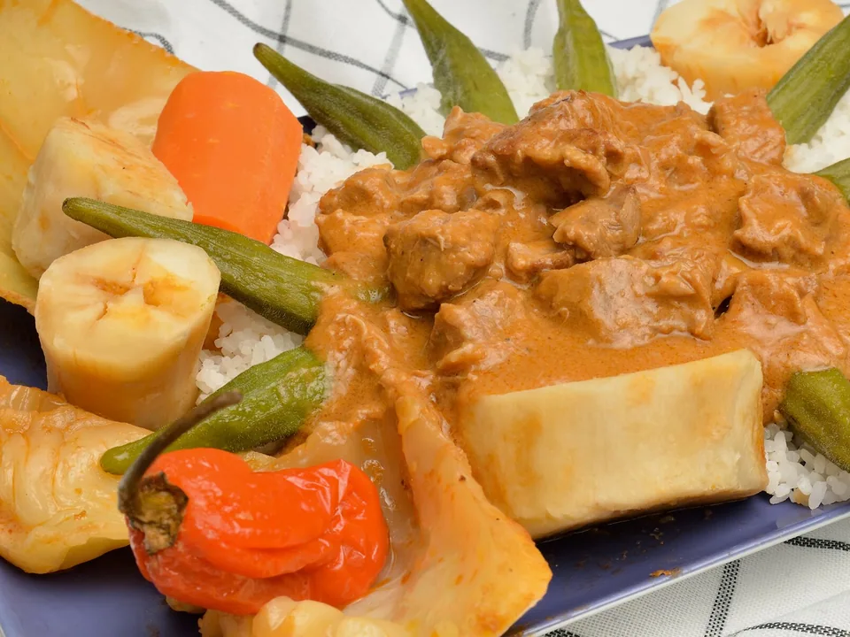Senegalese chicken mafé peanut stew with sweet potato, carrots and cabbage over rice