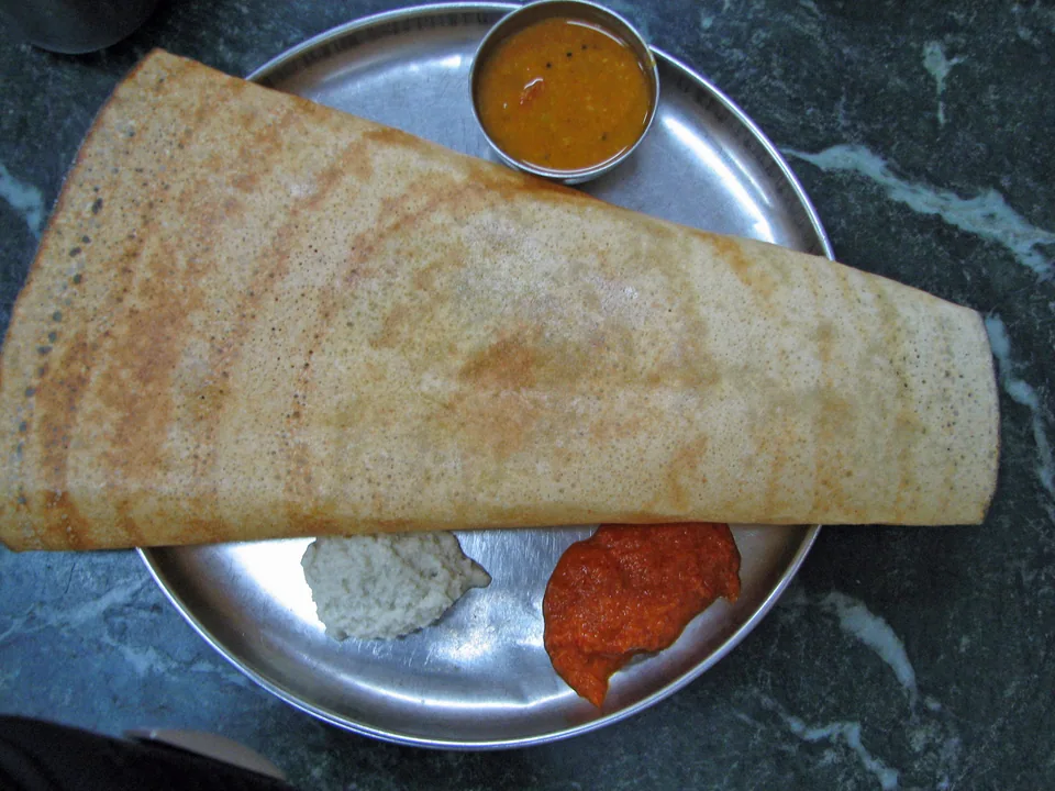 Crisp rolled masala dosa filled with yellow potato masala, served with sambar and coconut chutney
