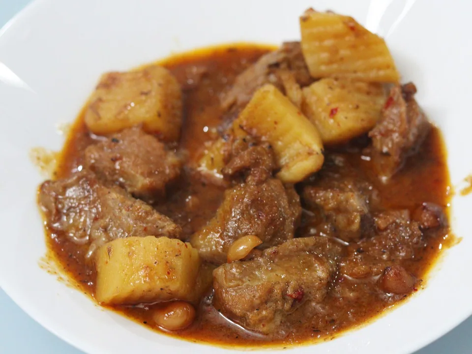 Beef Massaman curry with potatoes, onions, peanuts, coconut sauce, and warm spices