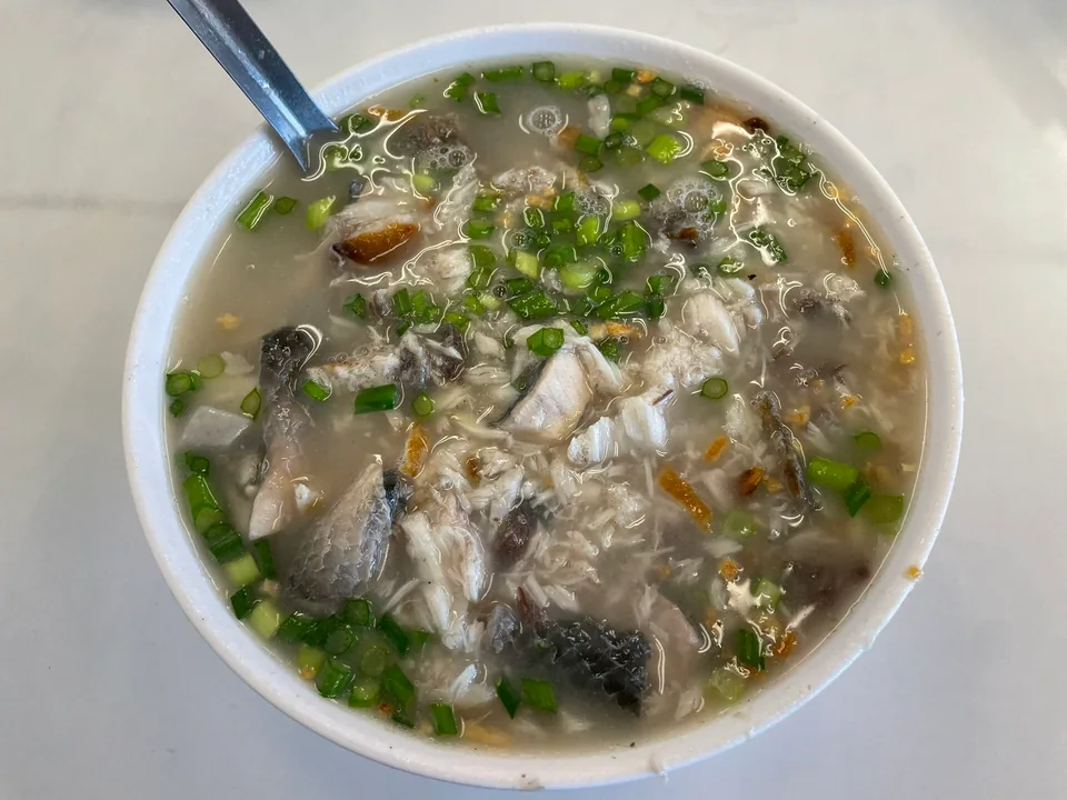 Tainan milkfish savoury congee with intact rice grains, milkfish belly, ginger, celery, and fried garlic