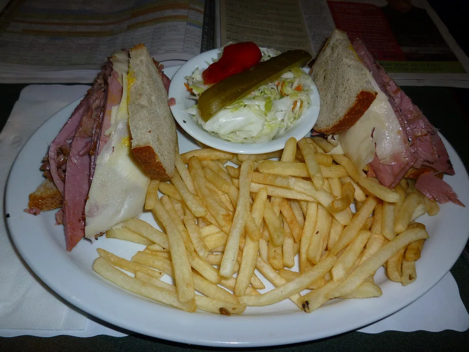 Montréal smoked meat piled on rye bread with mustard and dill pickle