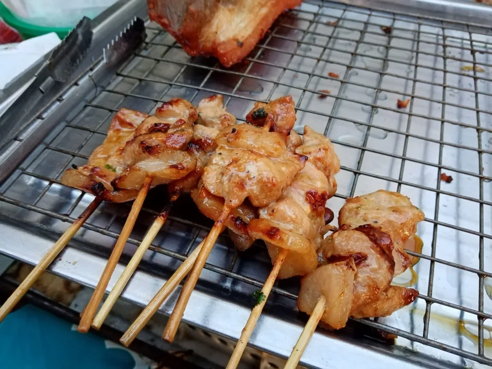 Moo Ping pork skewers with glossy coconut caramelization and charred grill edges