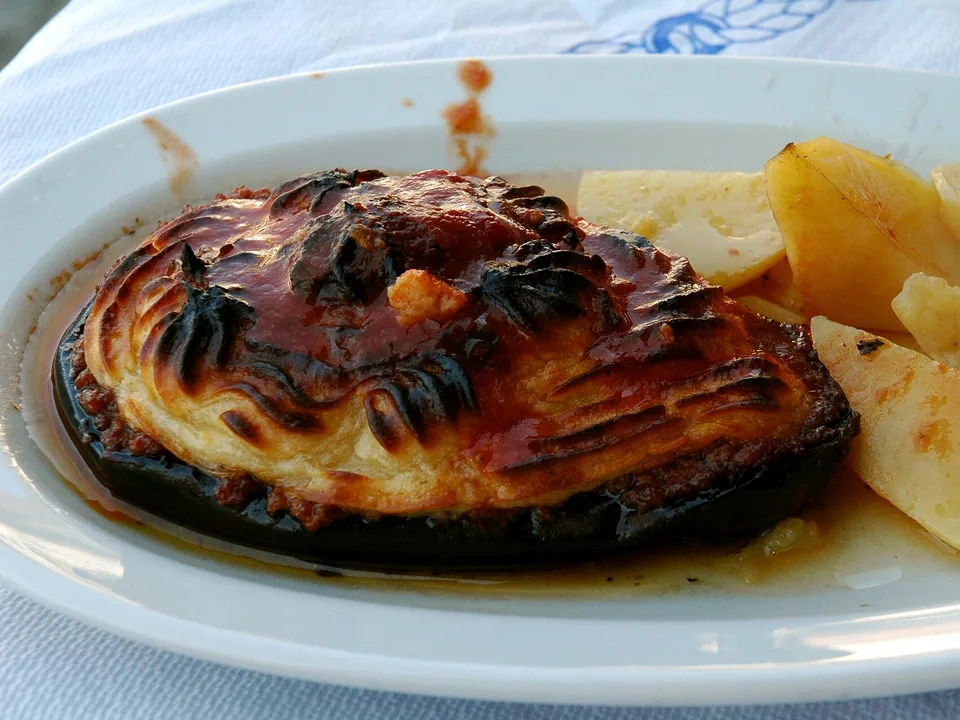 Greek moussaka slice with eggplant, minced meat sauce and golden béchamel