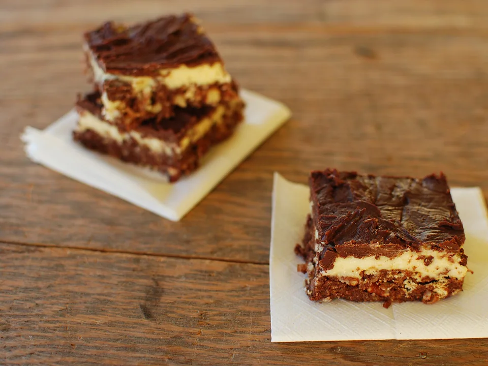Layered Nanaimo bars with chocolate, custard and coconut crumb base