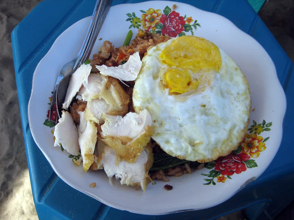 Indonesian nasi goreng with vegetables and a crisp-edged fried egg