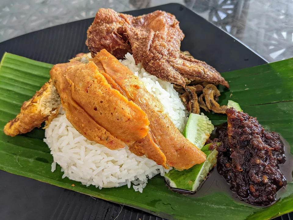 Malaysian nasi lemak with pandan coconut rice, anchovy sambal, peanuts, egg and cucumber