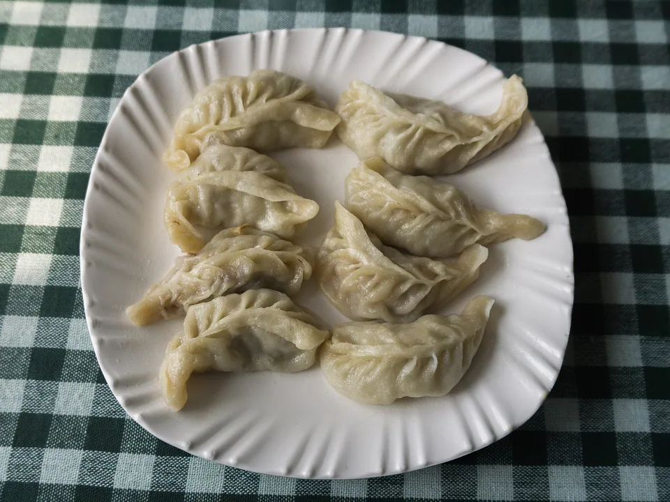 Nepali chicken momos served with tomato-sesame achar