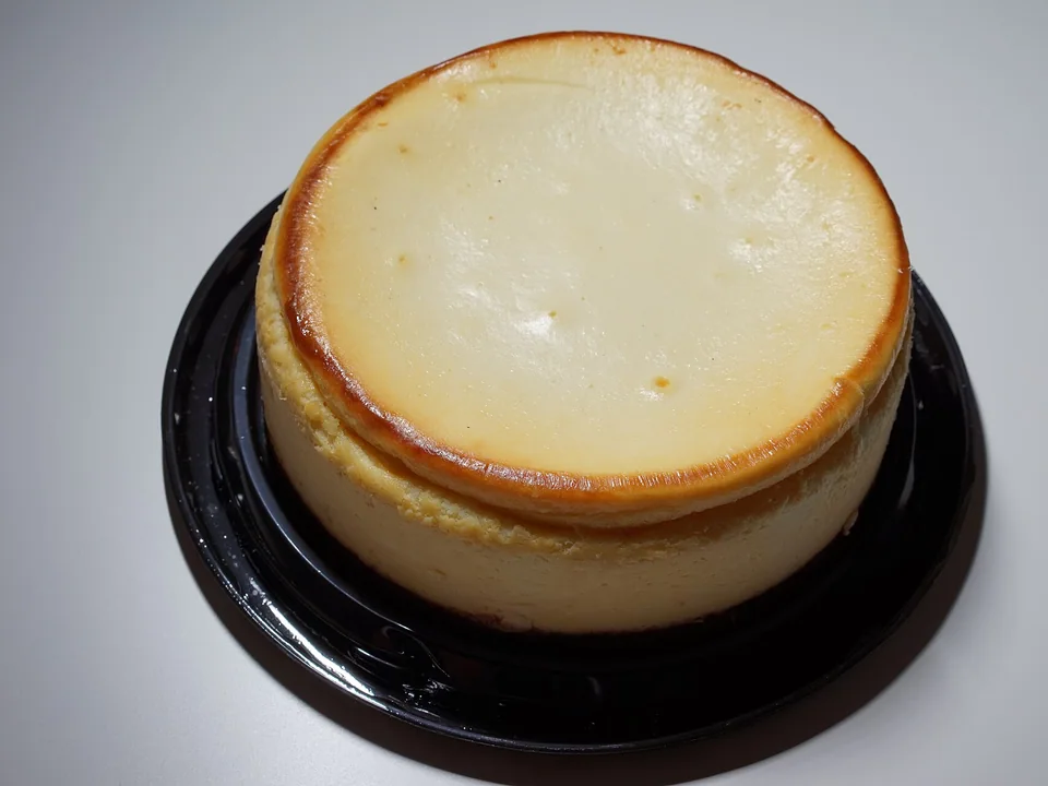 Tall New York cheesecake with a graham crust and creamy interior