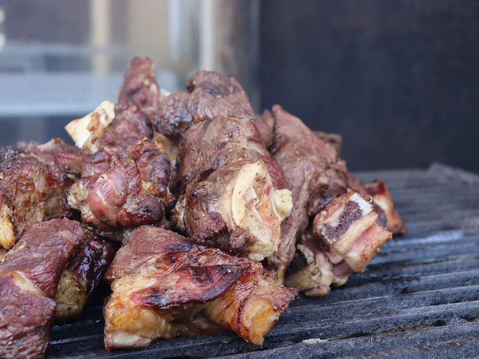 Kenyan charcoal-grilled nyama choma goat with kachumbari tomato-onion salad and ugali