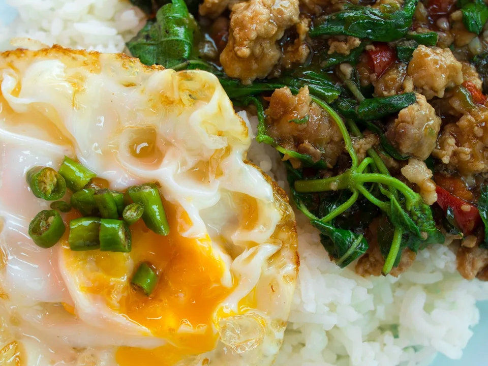 Pad Kra Pao ground pork with holy basil, rice, and a crisp-edged fried egg