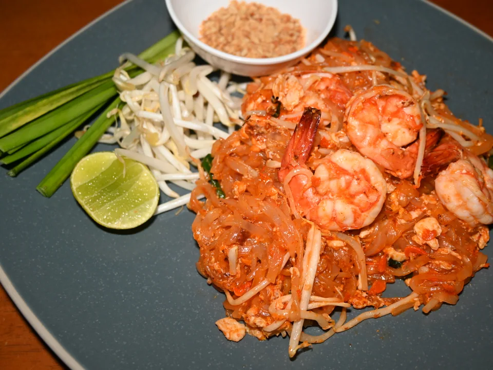 Shrimp Pad Thai with tofu, egg, bean sprouts, chives, peanuts, and lime