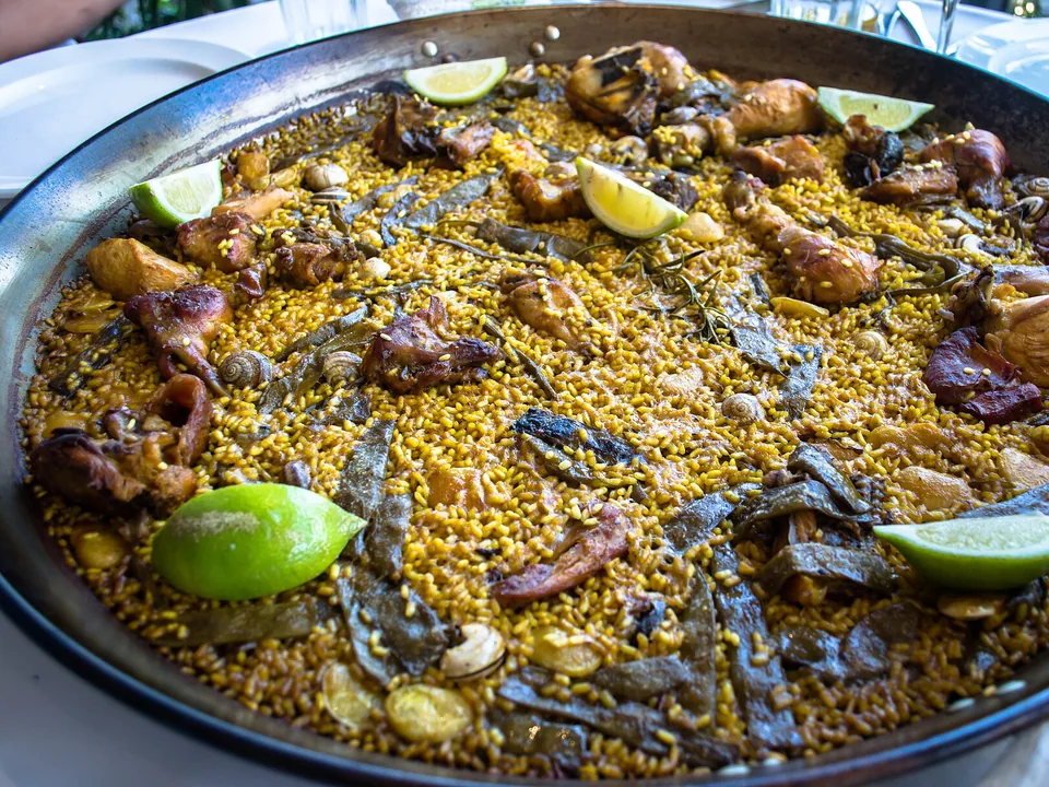 Valencian paella with golden rice, chicken, rabbit, green beans and white beans