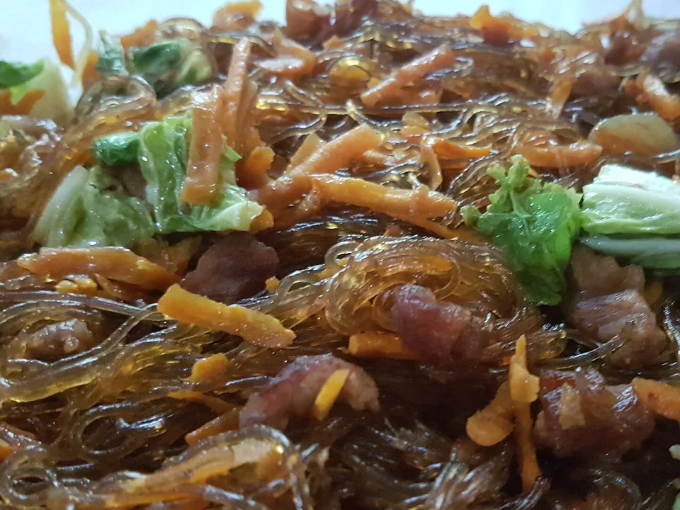Filipino bihon rice noodles stir-fried with chicken, shrimp, sausage and vegetables