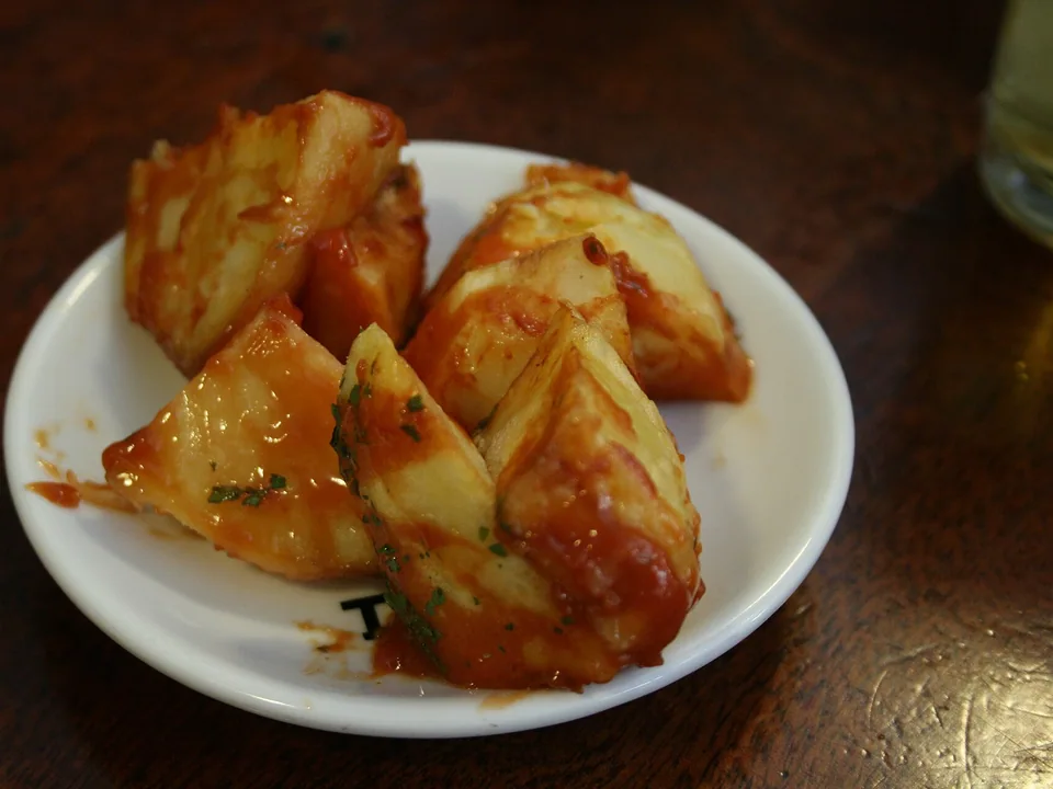 Crisp golden patatas bravas with red paprika tomato sauce