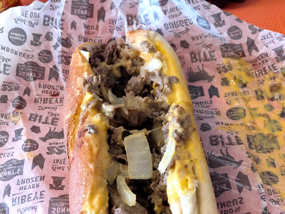Philly cheesesteak with thin beef, onions and melted provolone